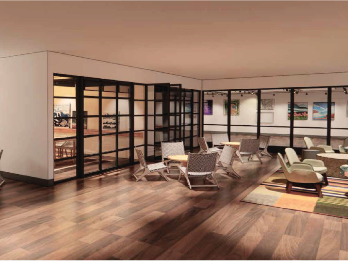 A modern lounge area with hardwood floors, contemporary furniture, glass partitions, wall art, and a mix of seating options including chairs and a sofa.